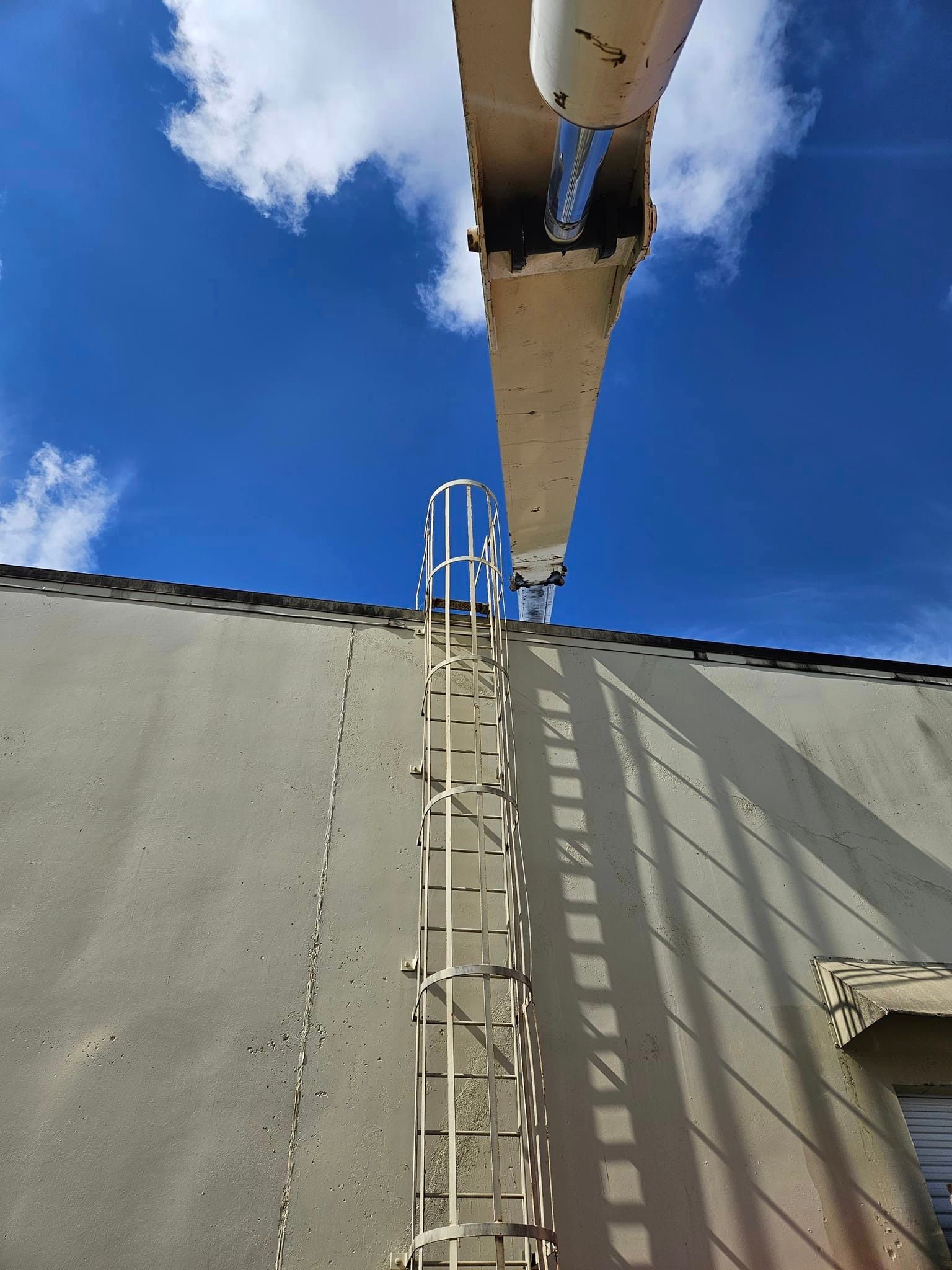 A ladder is attached to the side of a building.