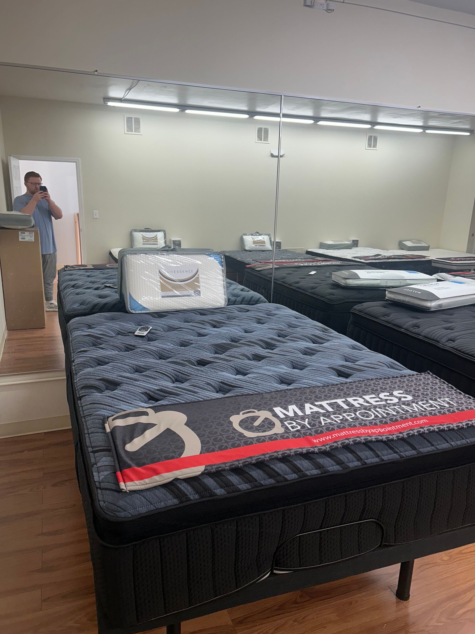 Mattresses on display in a brightly lit showroom