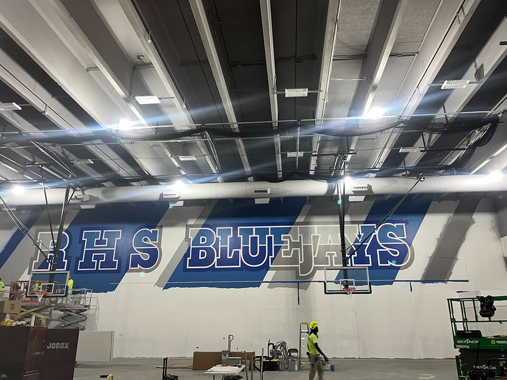 A large mural on the wall of a building that says hs blue jays