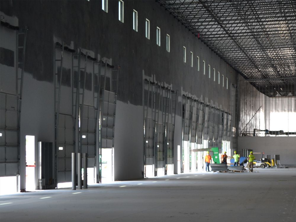 A large empty warehouse with a lot of windows