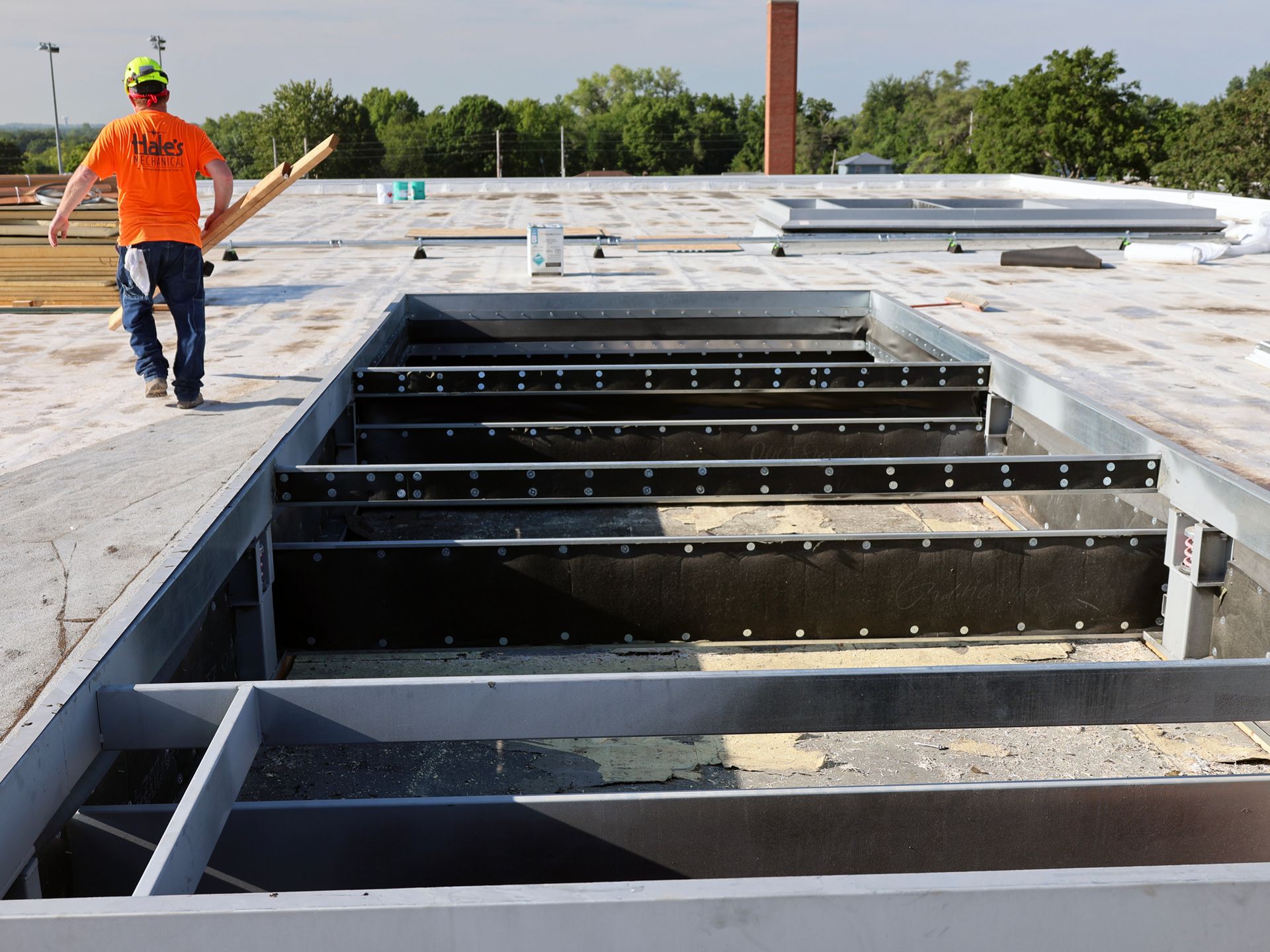 A man wearing an orange shirt with the word safety on it