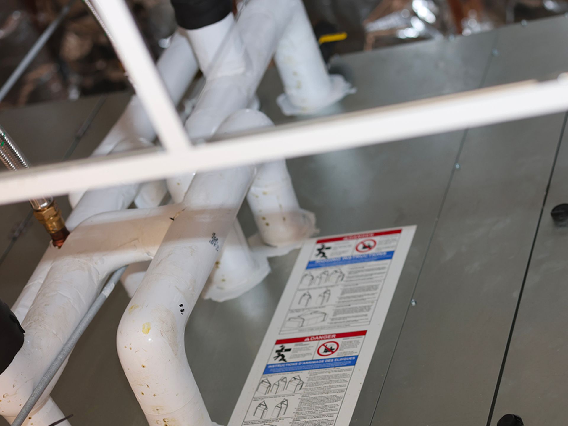 A white pipe with a sticker on it that says