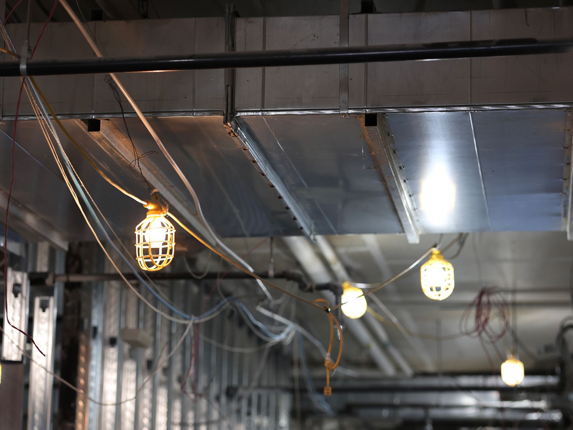 A bunch of lights hanging from the ceiling of a building