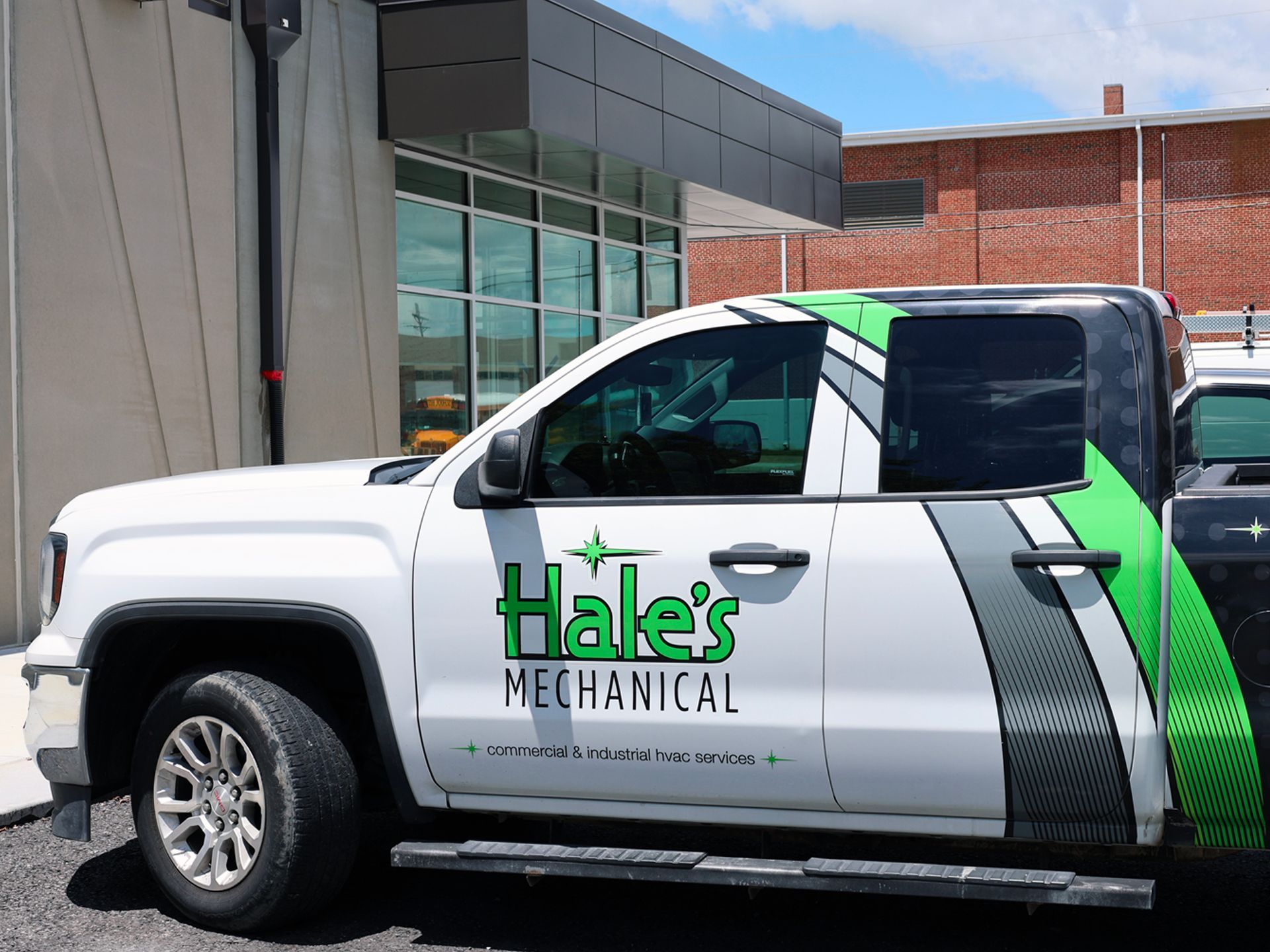 A hale 's mechanical truck is parked in front of a building