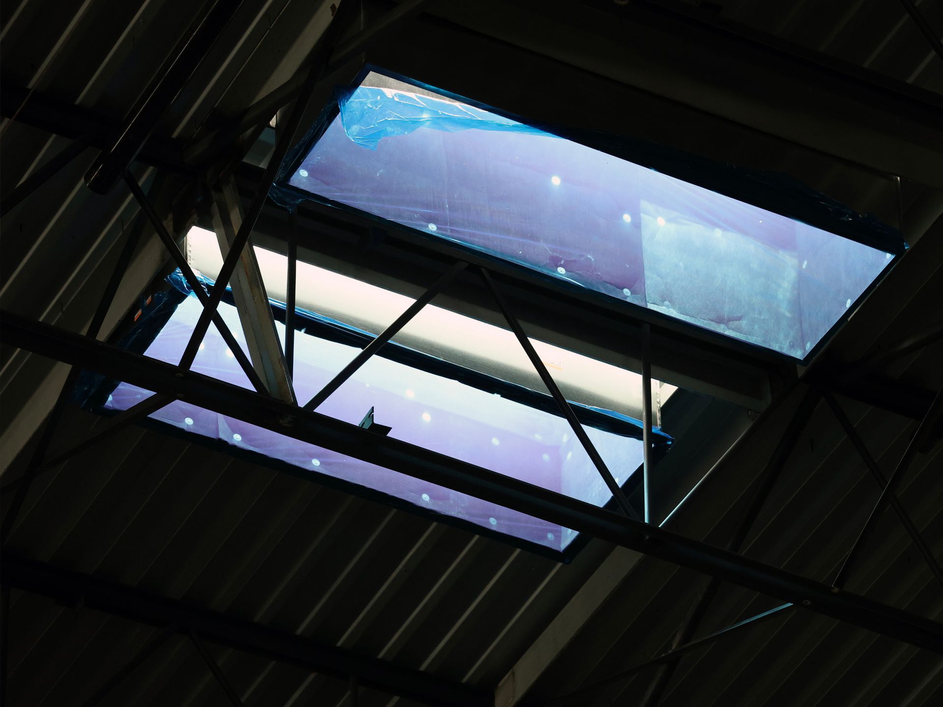A ceiling with a skylight that looks like a galaxy