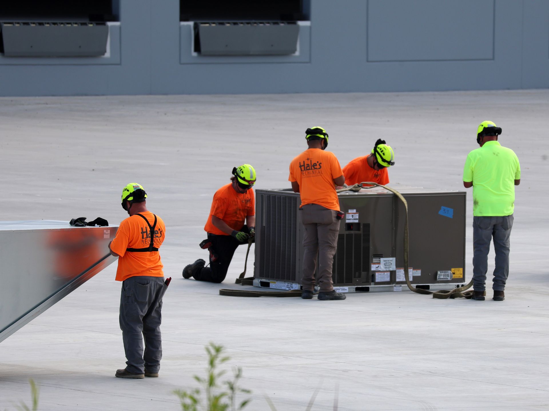 A group of construction workers are working on a roof