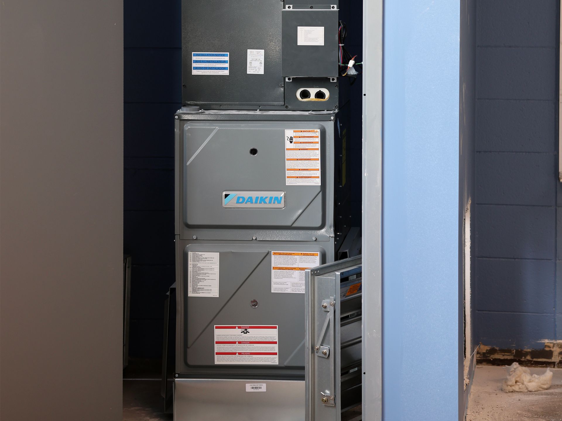 A daikin air conditioner is stacked on top of each other in a room.