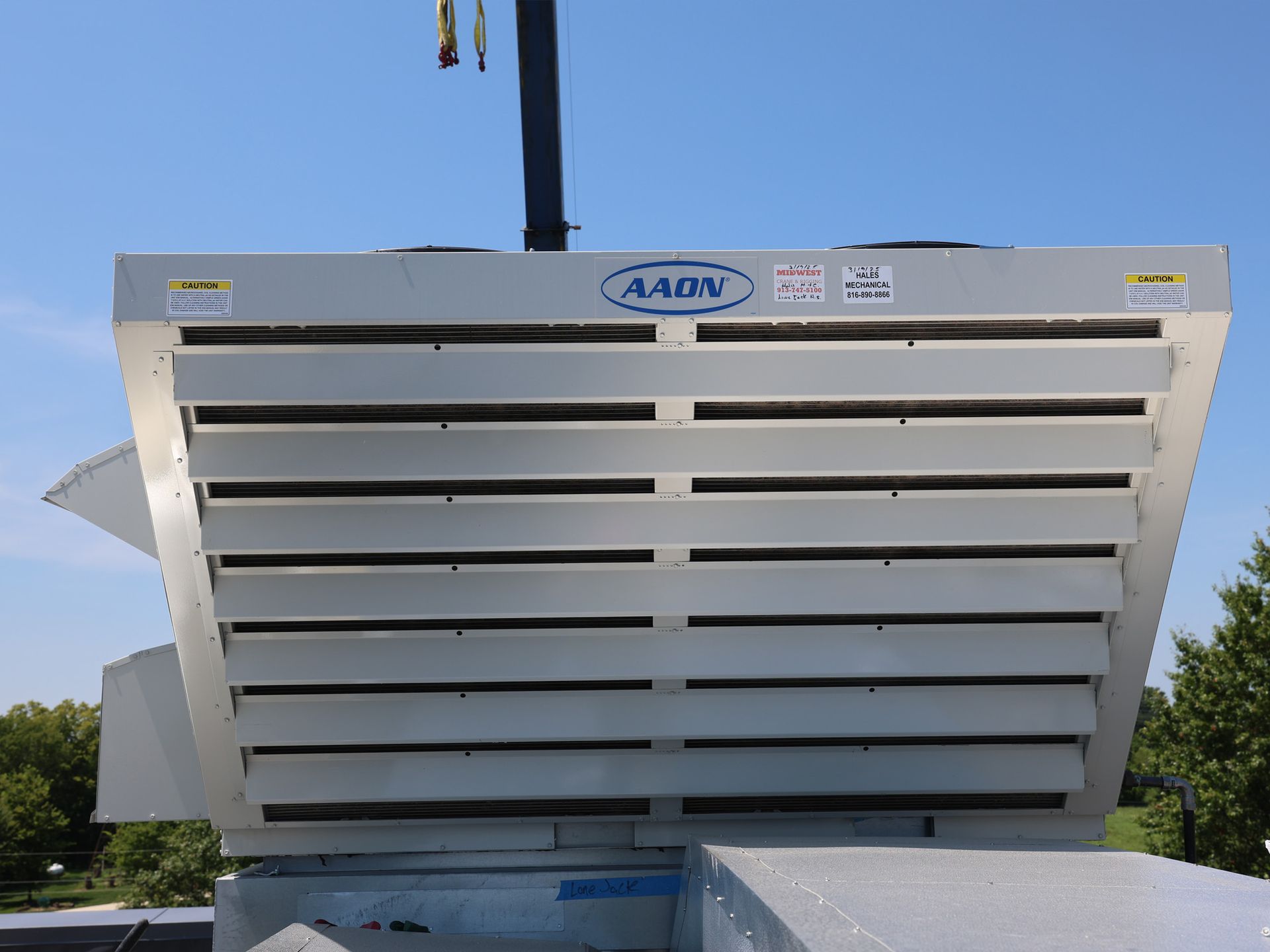 A large, industrial HVAC unit on a rooftop with the name 