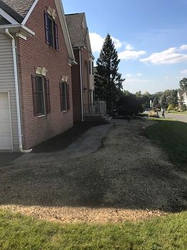 A large brick house with a driveway leading to it.