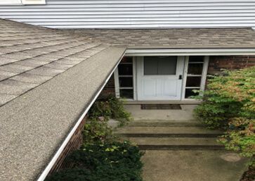Gray asphalt shingle roof with Gutter Cap.