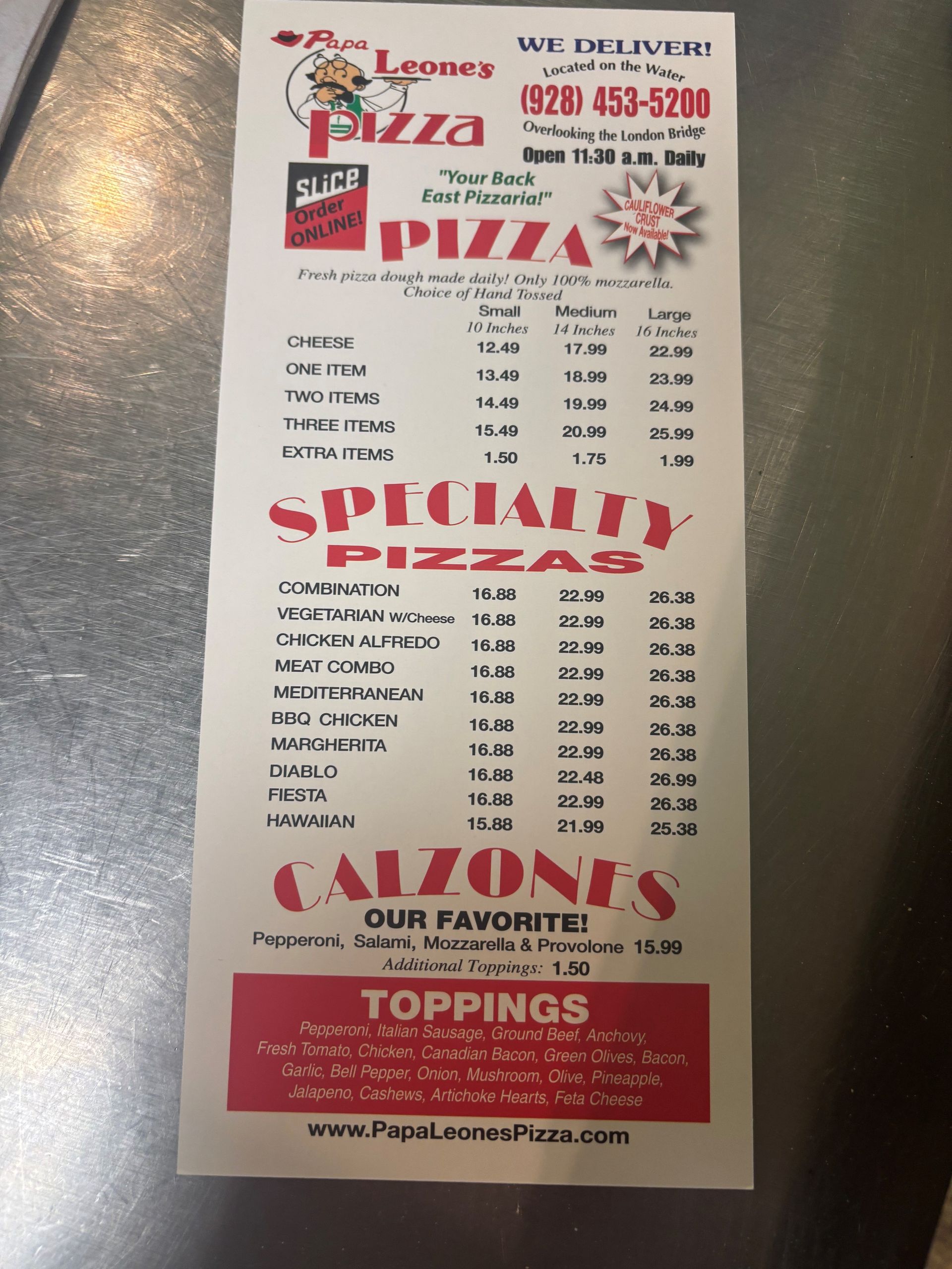Papa Leone's Pizza menu, listing pizza, specialty pizzas, calzones, and toppings, with prices.