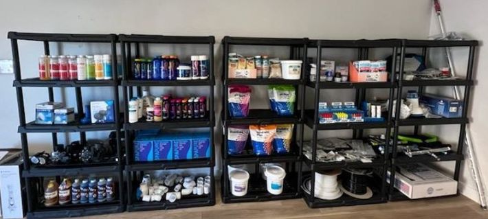 a row of shelves full of pool chemicals in a room