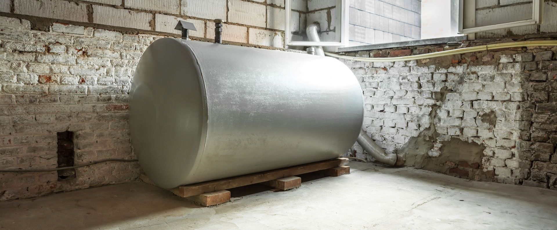 Two propane tanks are lined up in a parking lot
