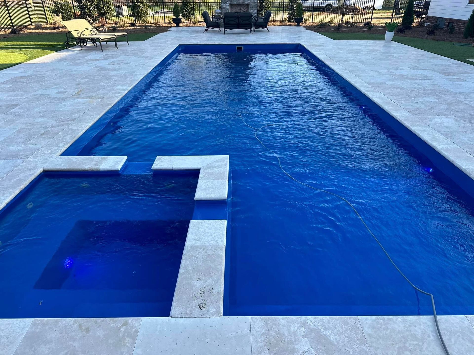 A large swimming pool with a waterfall in the middle of it.
