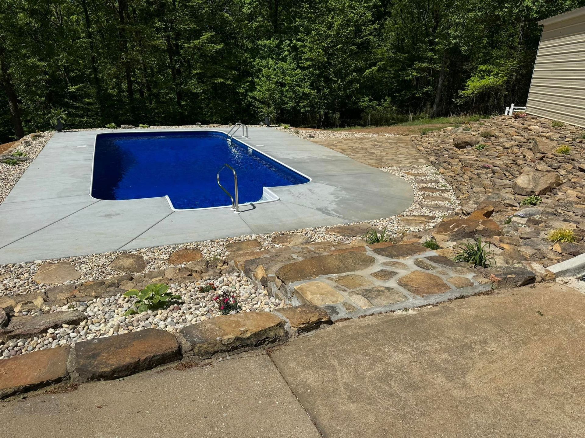 A large swimming pool with stairs leading to it.
