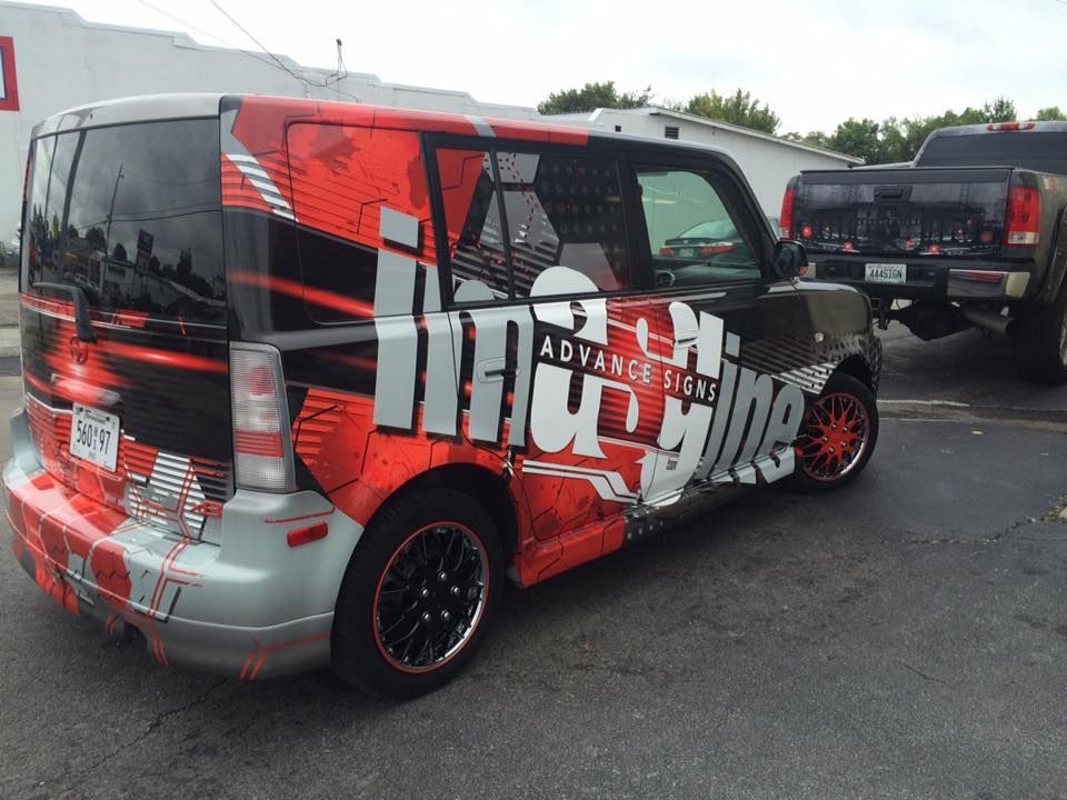 A red and black van with the word adventure on it