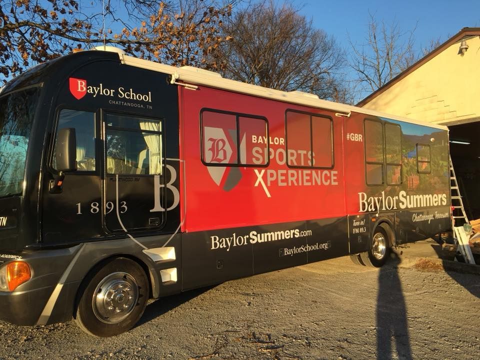 A red and black bus with the words sports xperience on it