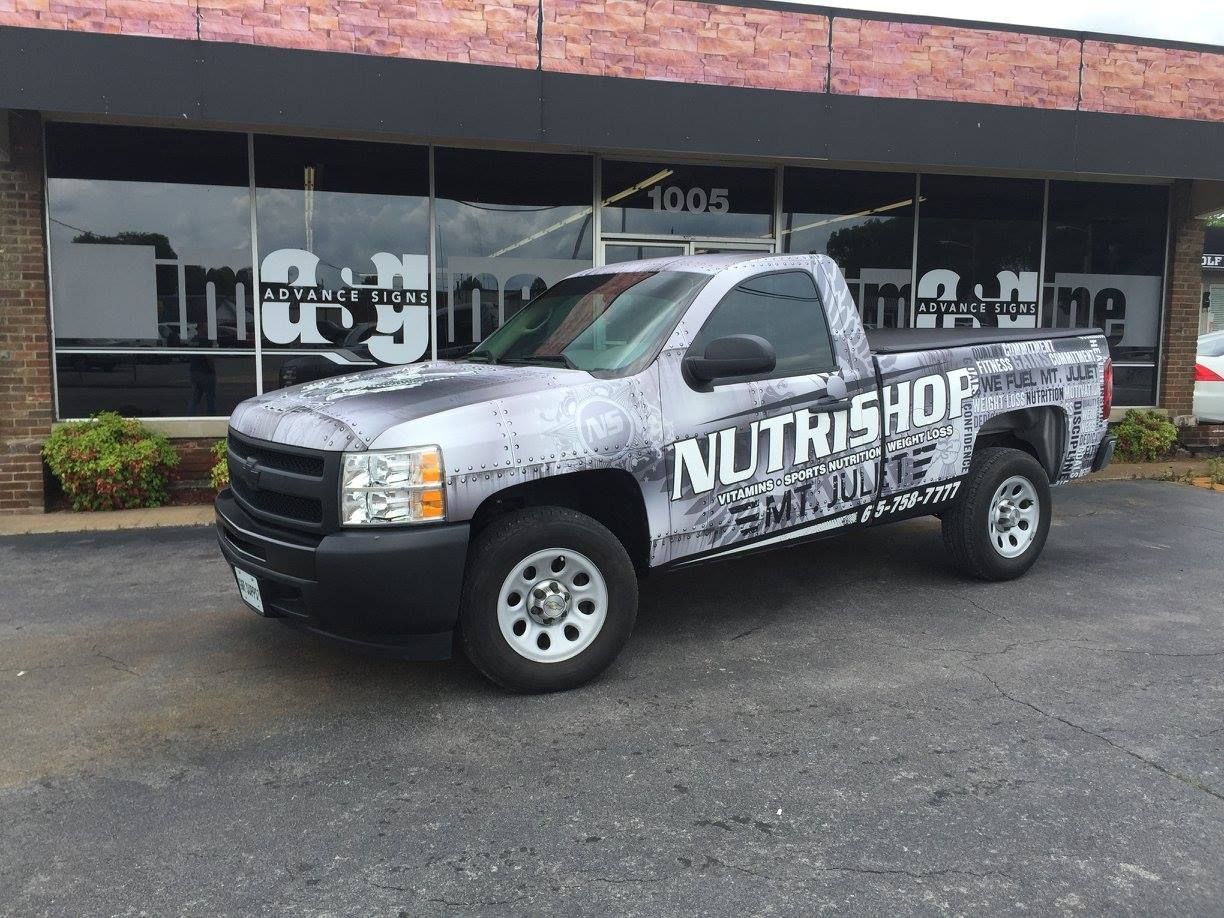 A trailer is parked in a garage with mountains on it.