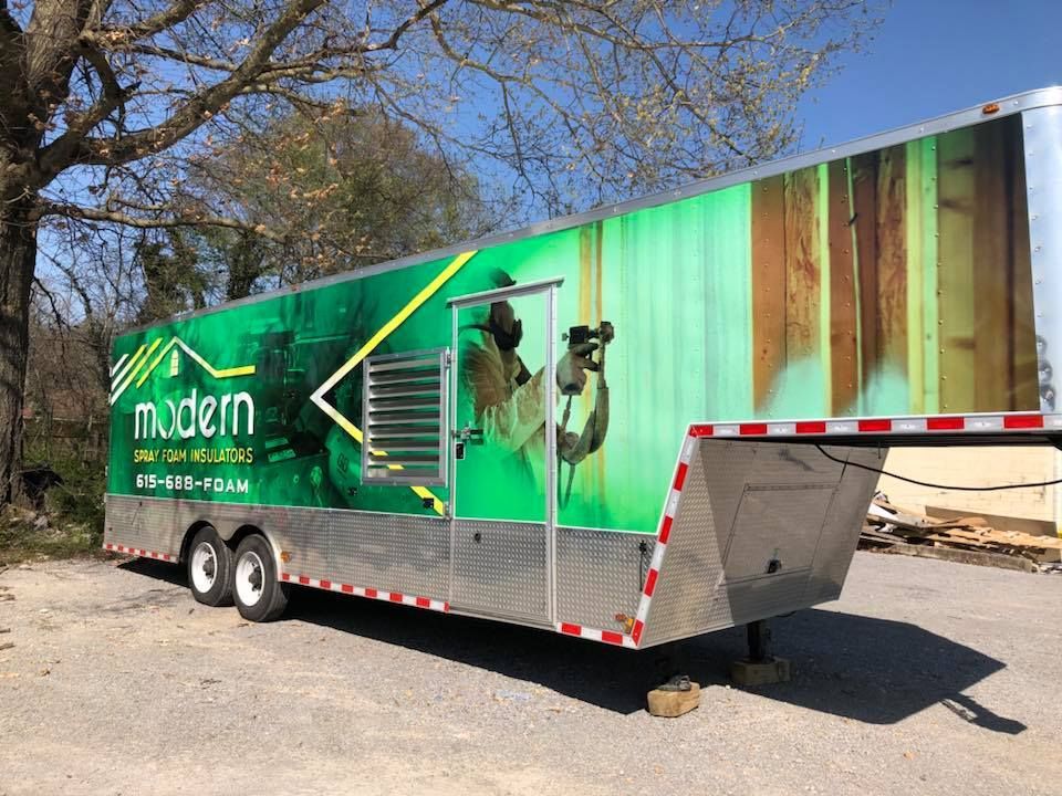 A green trailer with the word modem on it