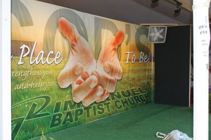 A sign for a baptist church with a picture of two hands