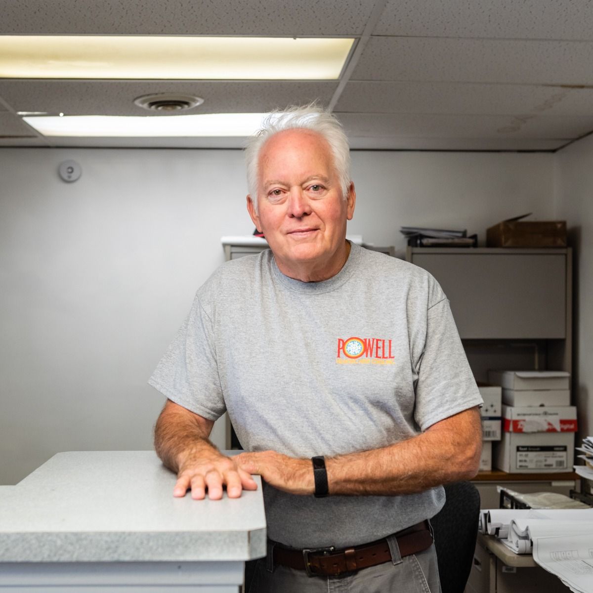 A man wearing a grey shirt with the word powell on it