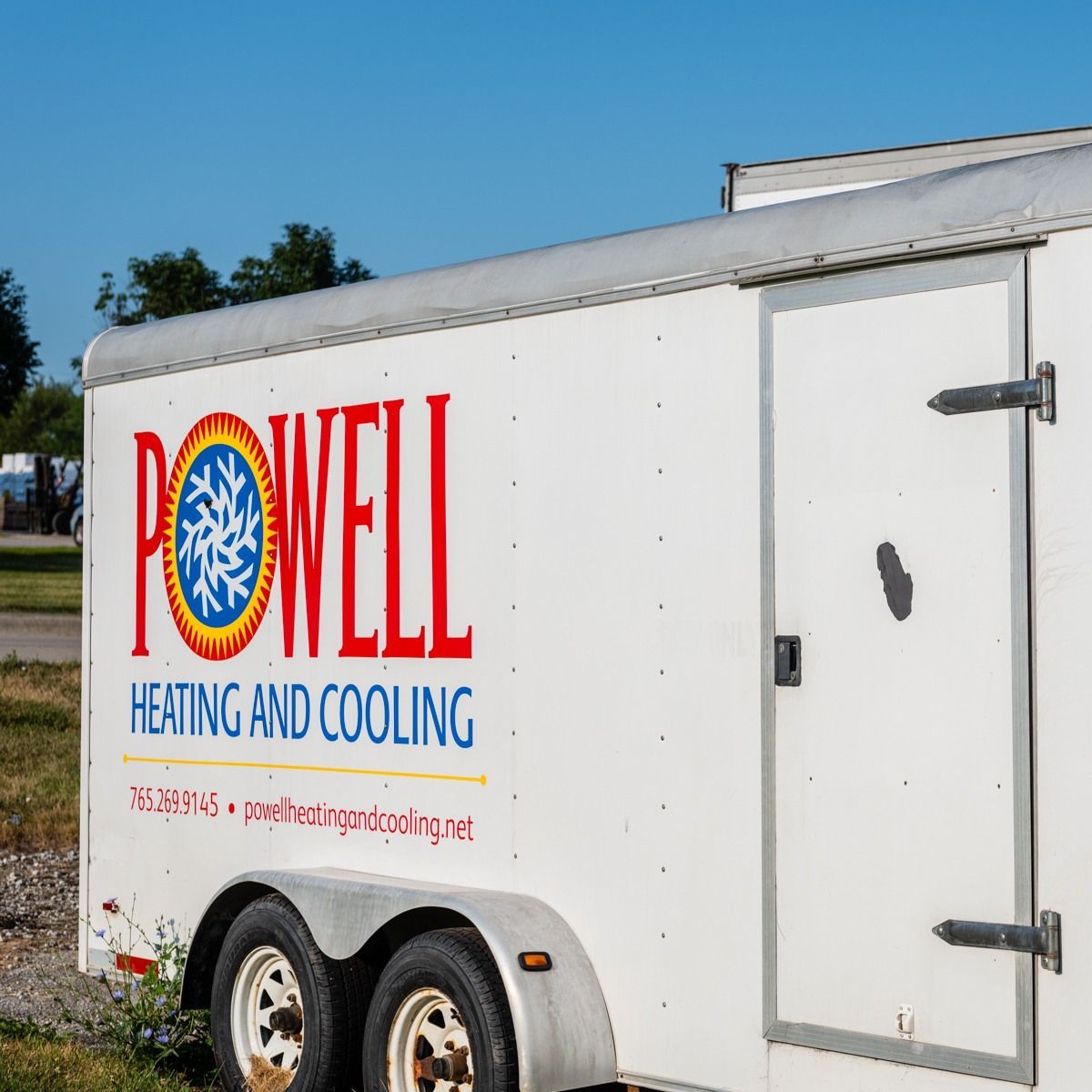 A white trailer that says powell heating and cooling on it