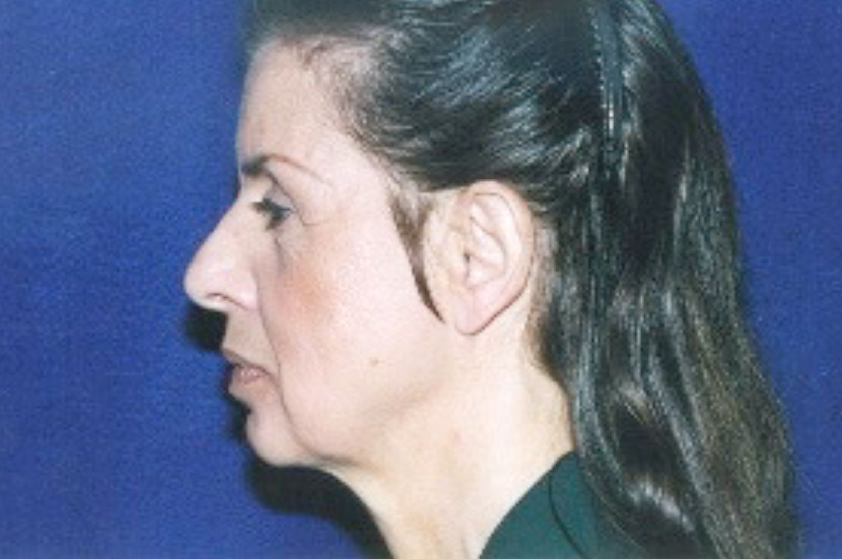 A close up of a woman's face against a blue background