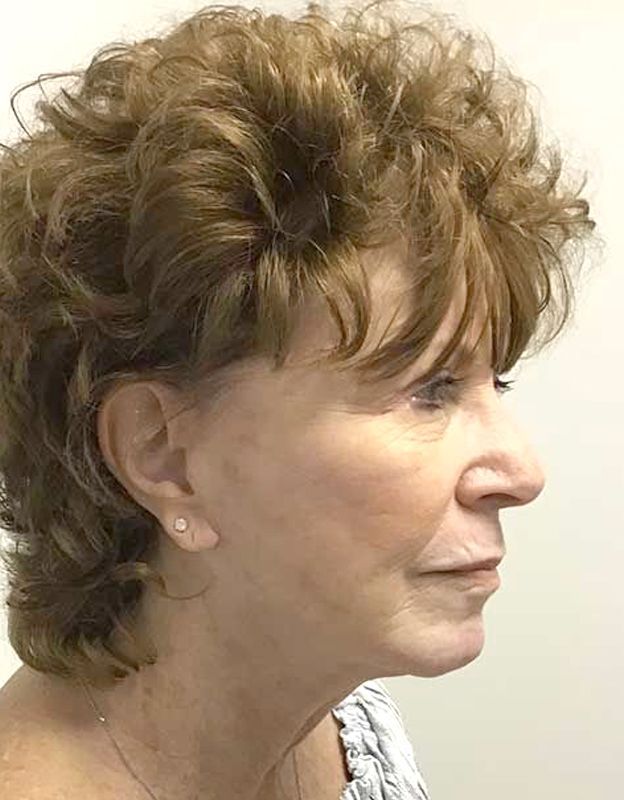 A woman with curly hair is sitting in a chair