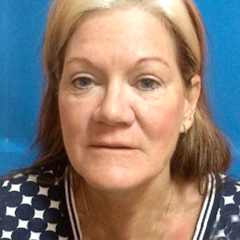 A close up of a woman's face with a blue background