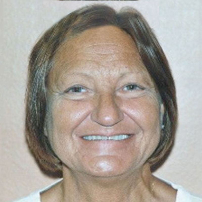 A close up of a woman's face with a smile on her face