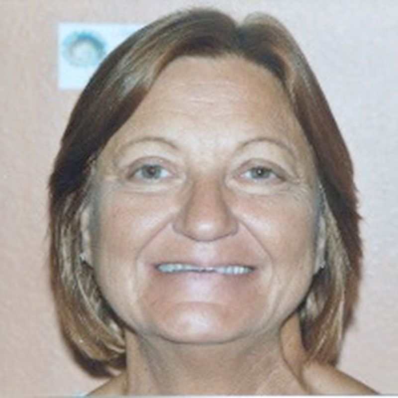 A close up of a woman's face with a smile on her face