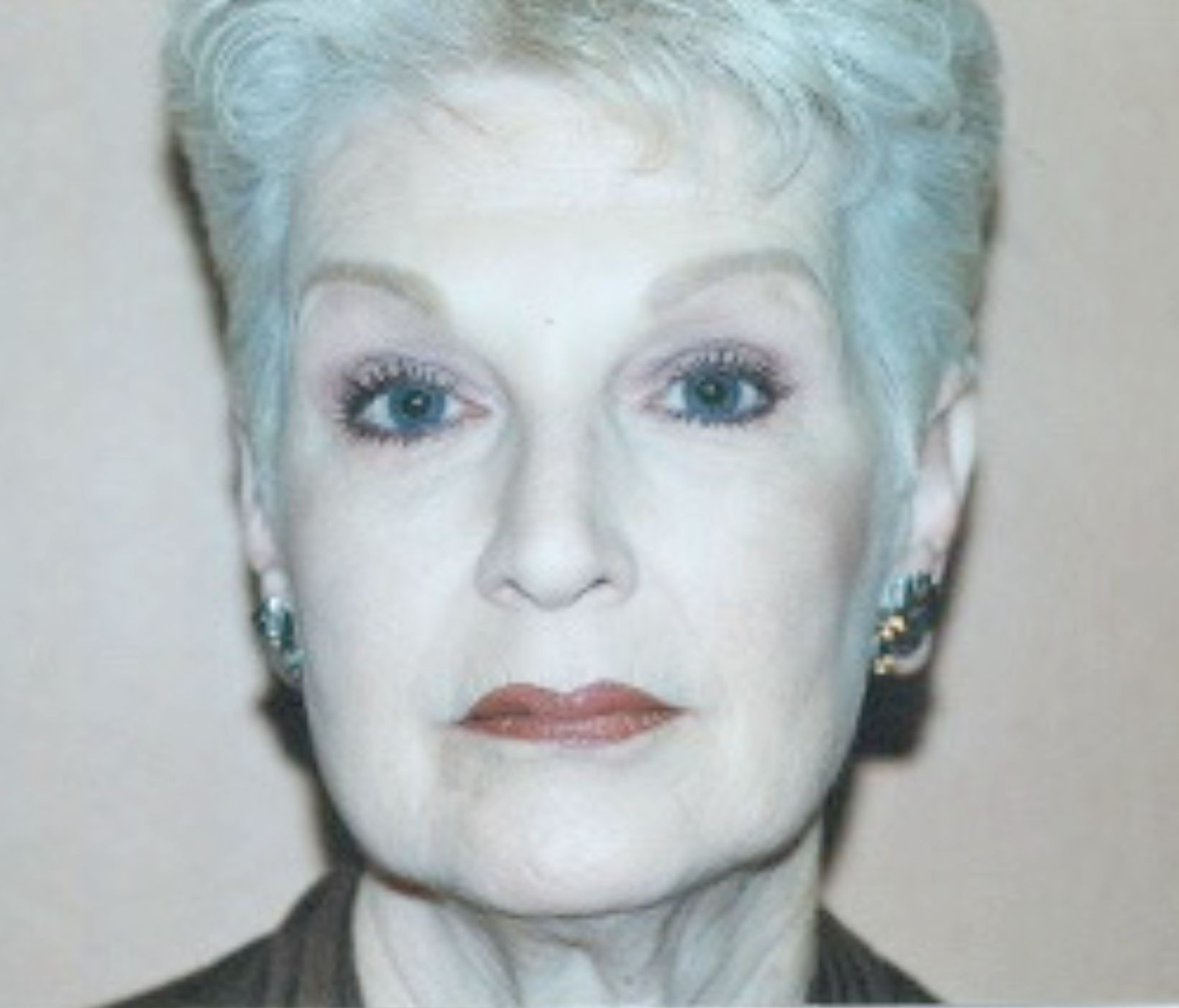 A close up of a woman's face with blue eyes