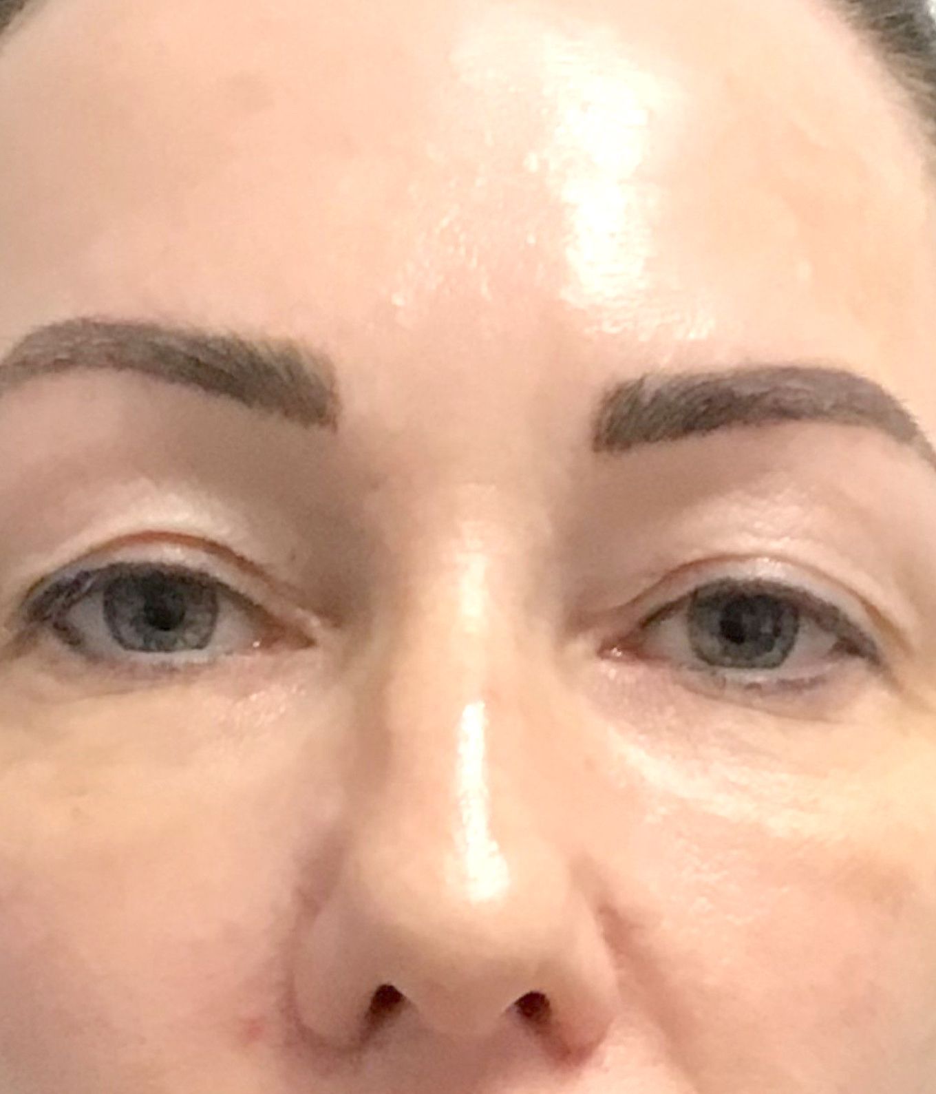 A close up of a woman's face with blue eyes