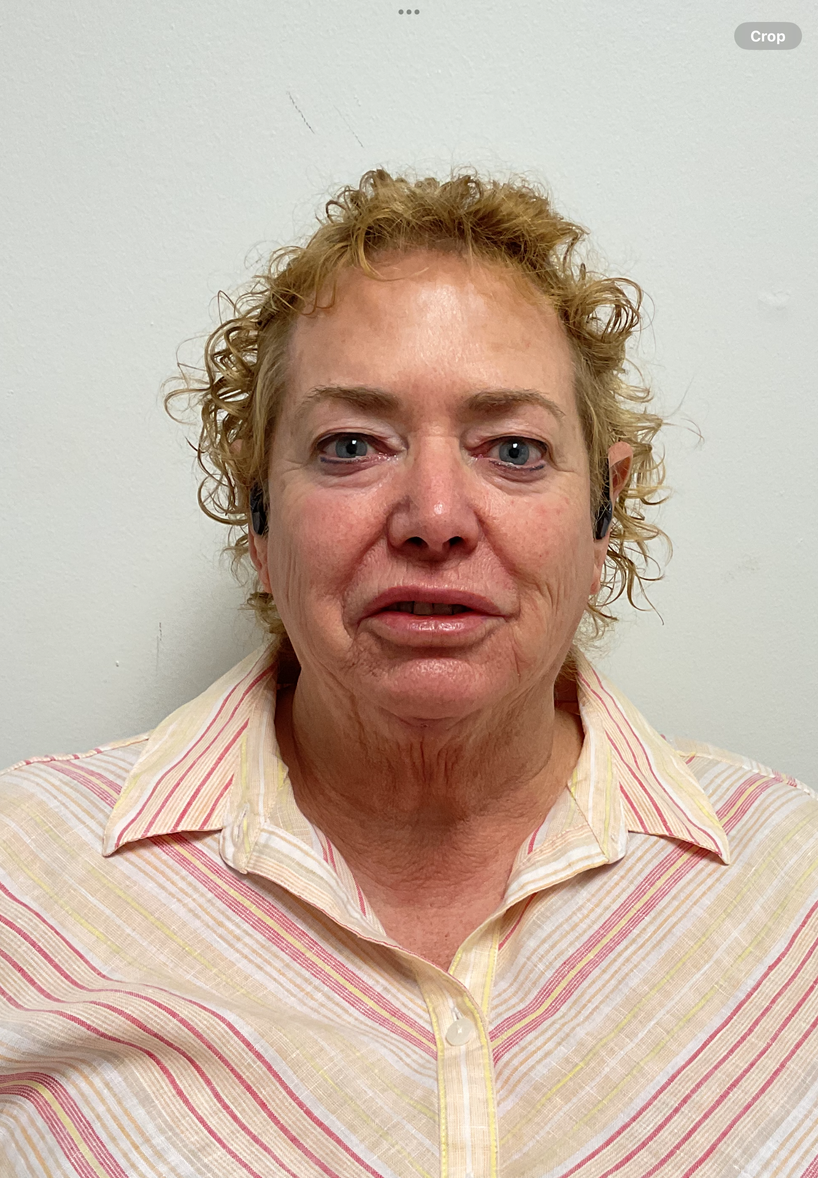 A woman with curly hair and a striped shirt