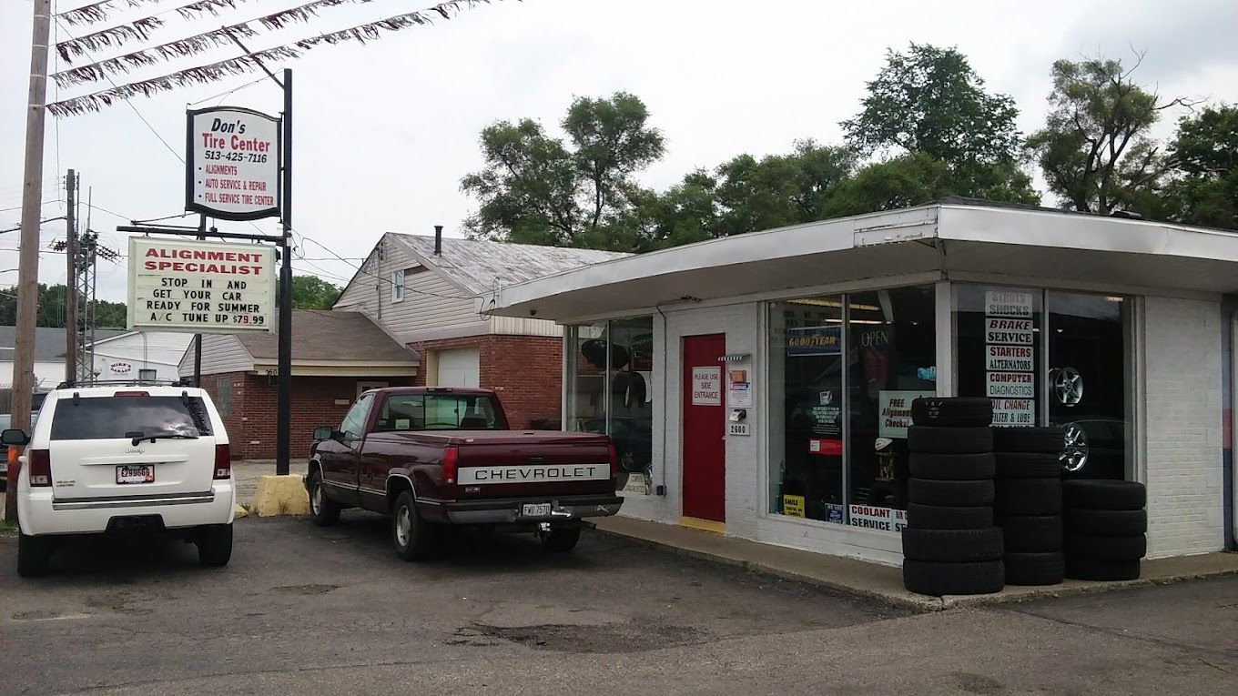 A truck is parked in front of a tire shop