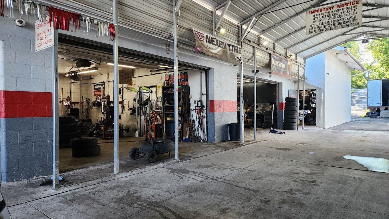 A large garage with a lot of tires in it.
