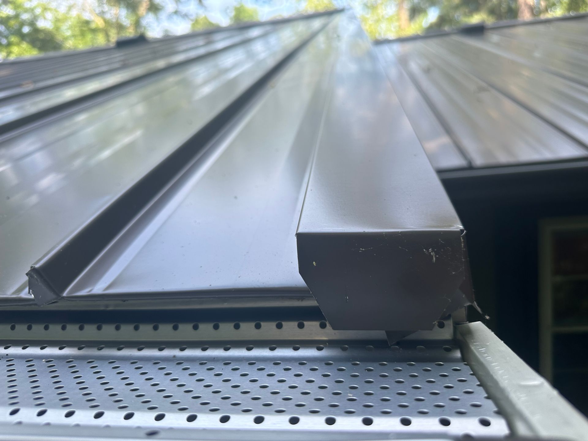 A close up of a metal gutter on a roof