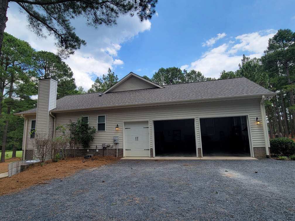 A house with two garage doors and a chimney