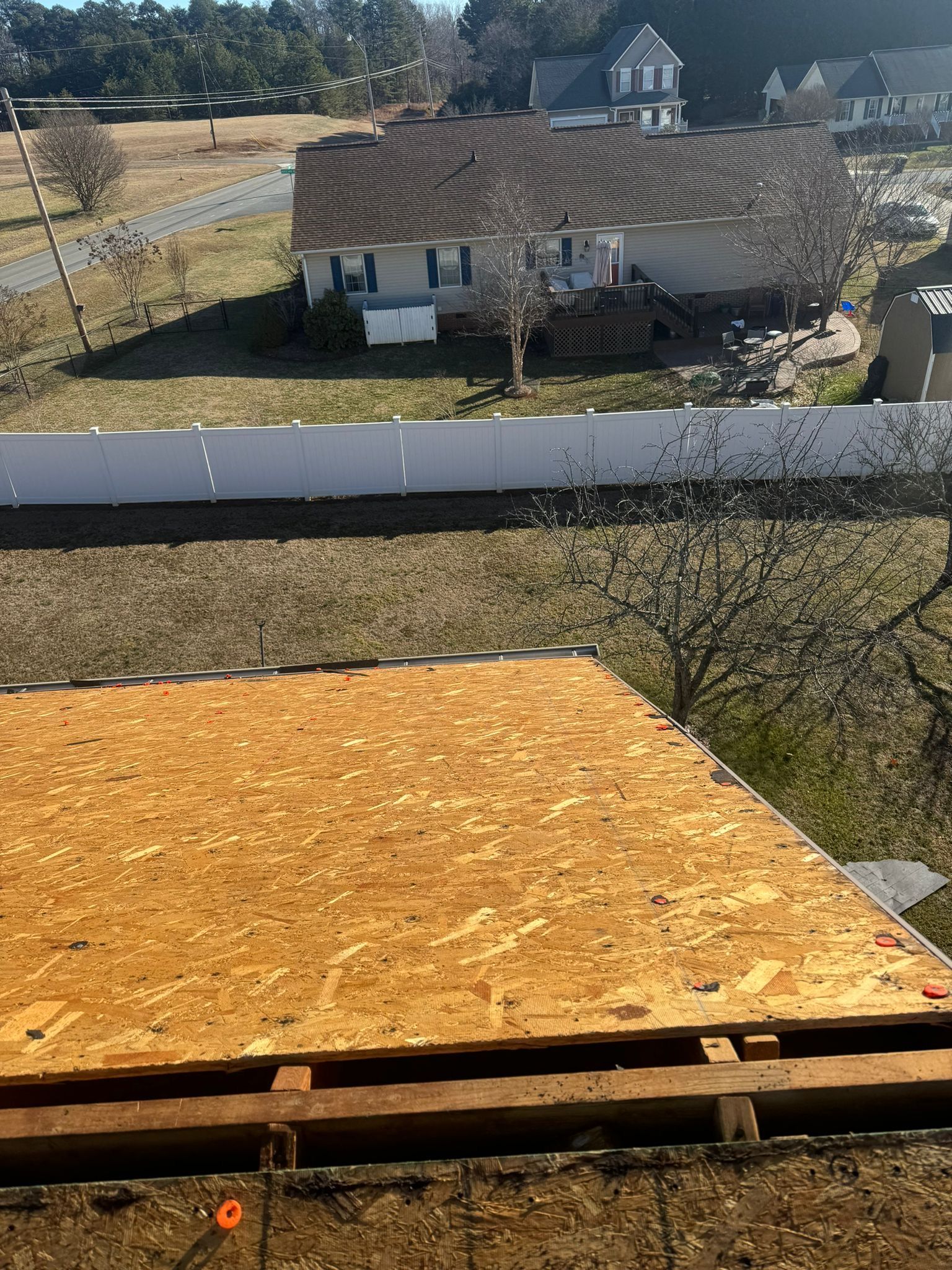 A large piece of plywood is sitting in front of a house.