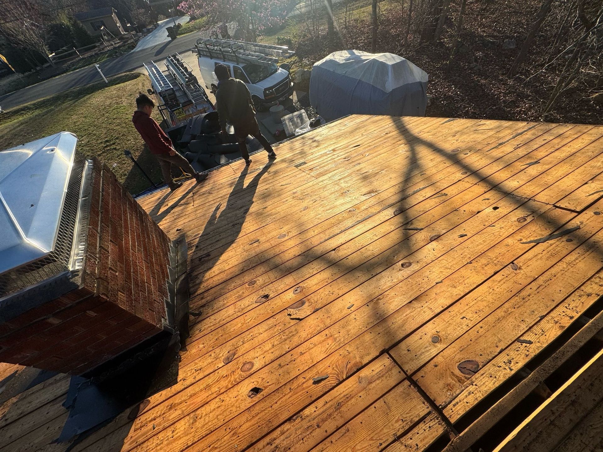 A group of people are standing on top of a wooden deck.