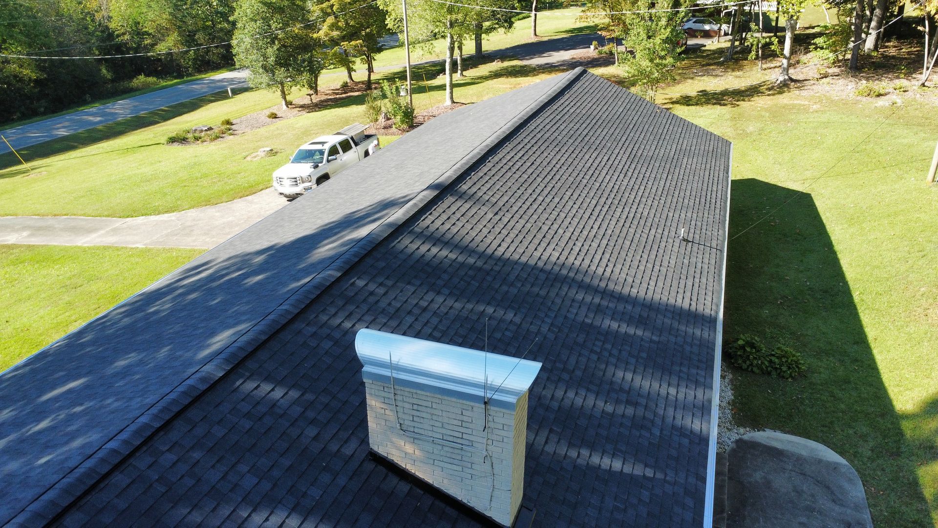 An aerial view of a house with a chimney on the roof.