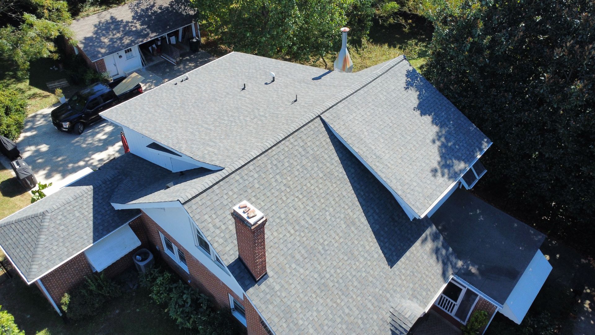 An aerial view of a house with a new roof.