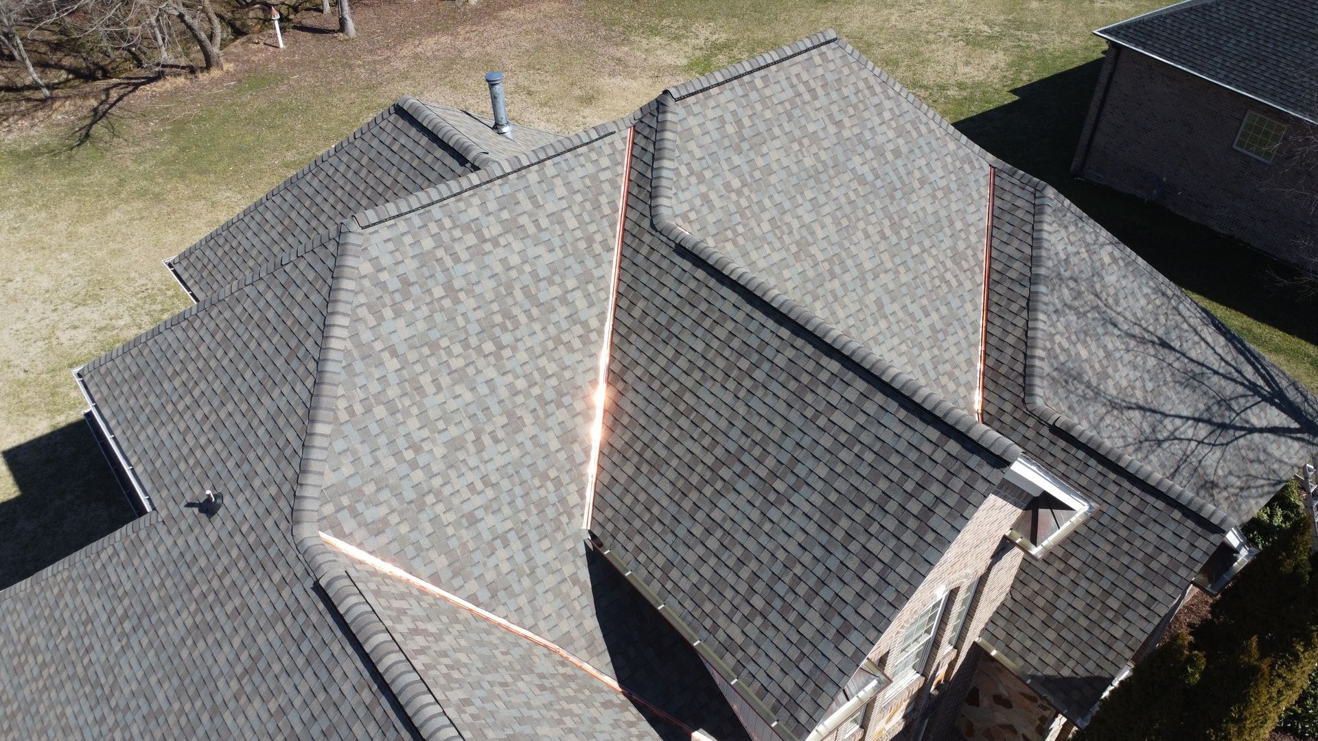 An aerial view of a house with a new roof.