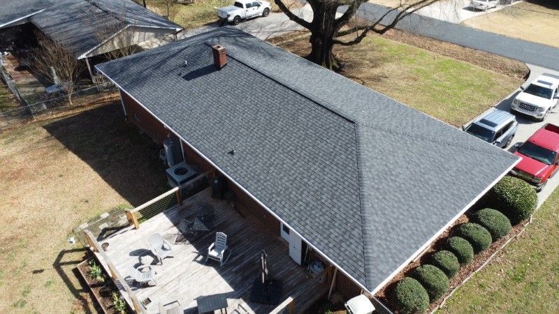 An aerial view of a house with a new roof.
