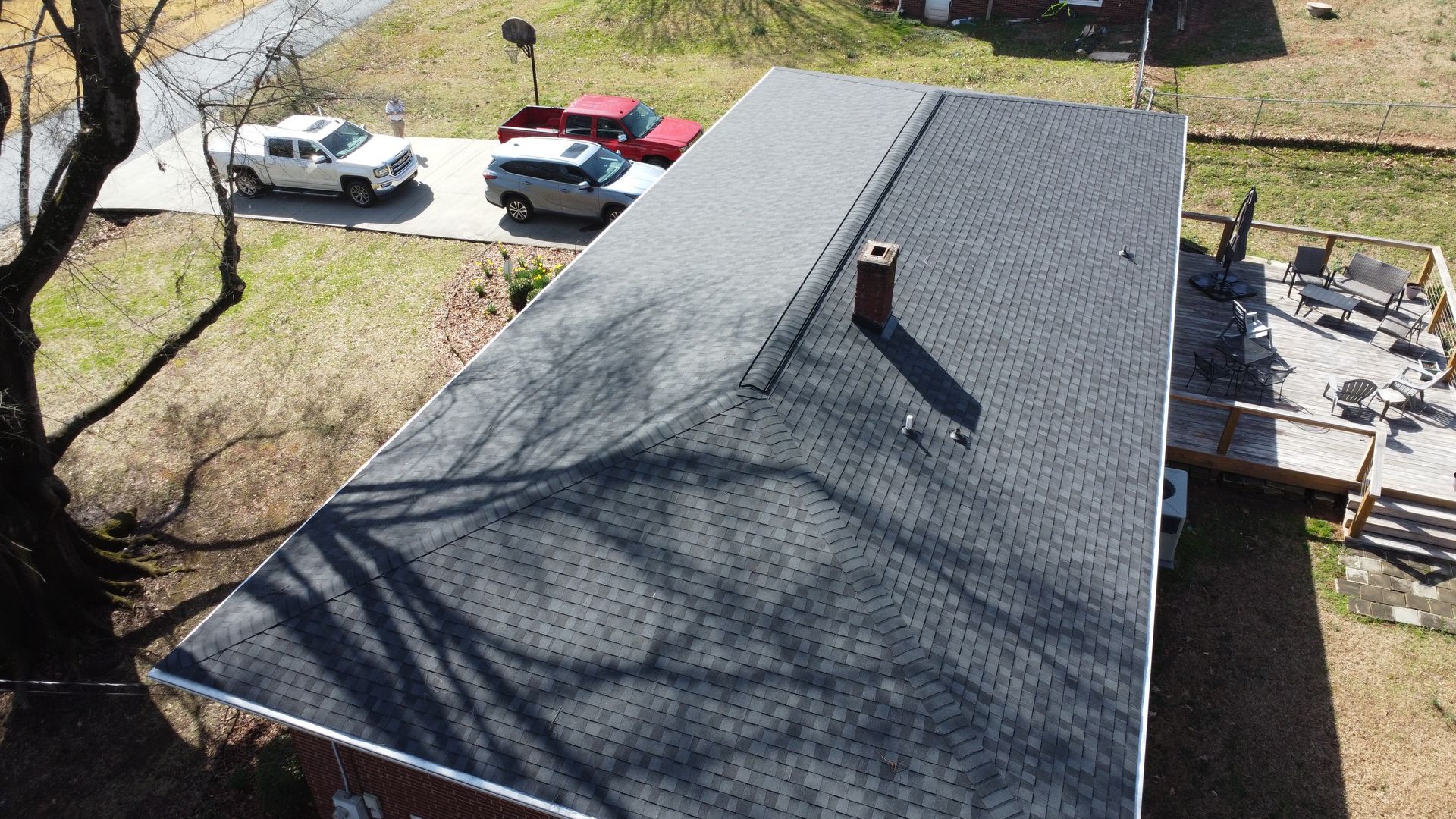 An aerial view of a house with a black roof.