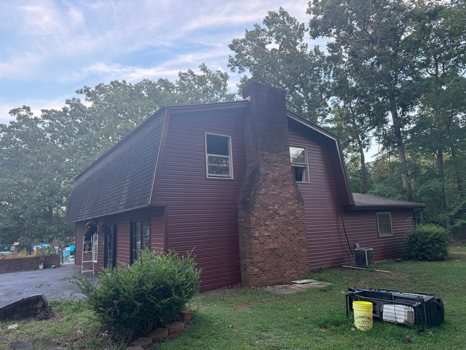 A log cabin is sitting in the middle of a lush green field.