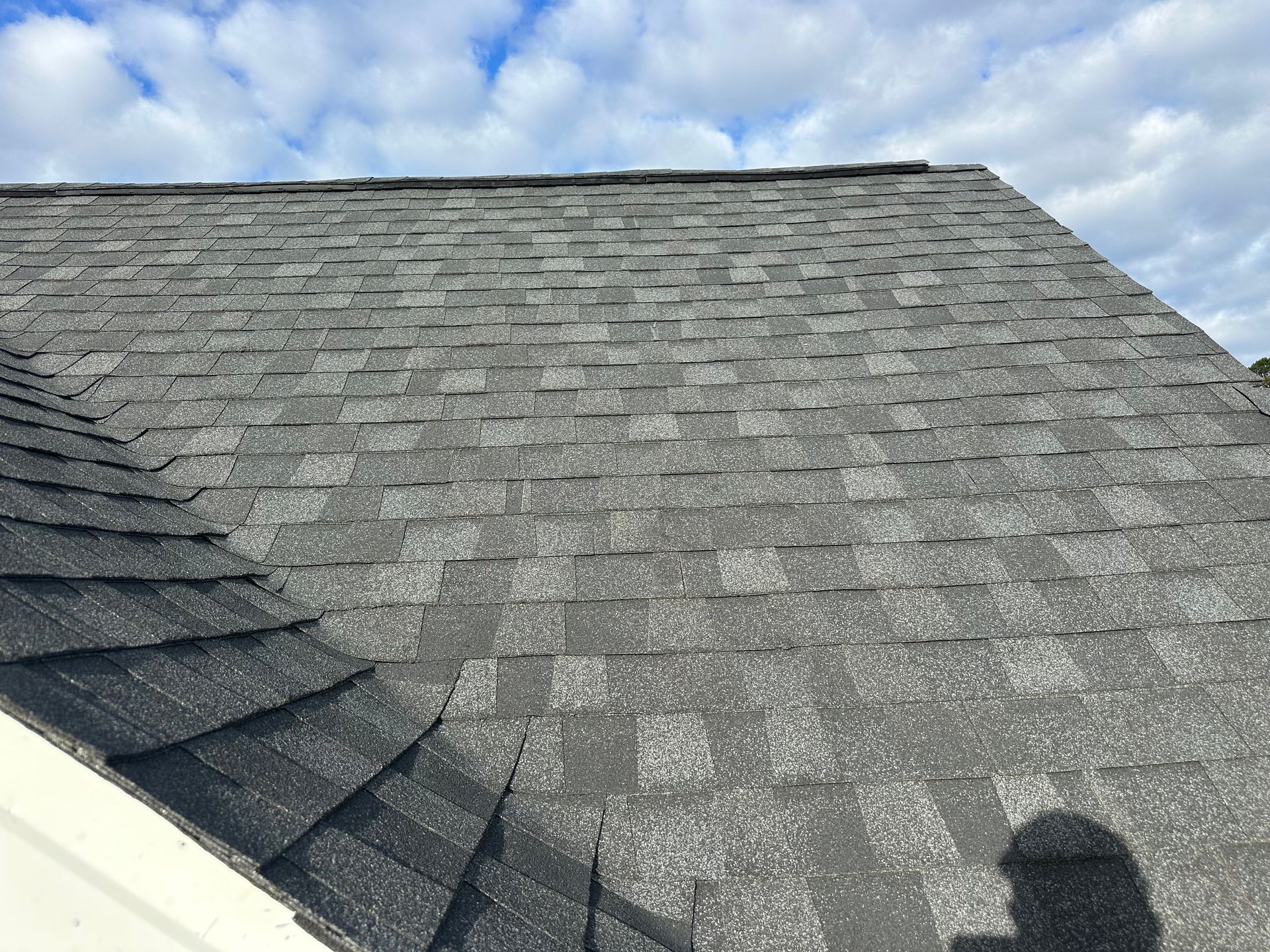 A close up of a roof with a blue sky in the background.