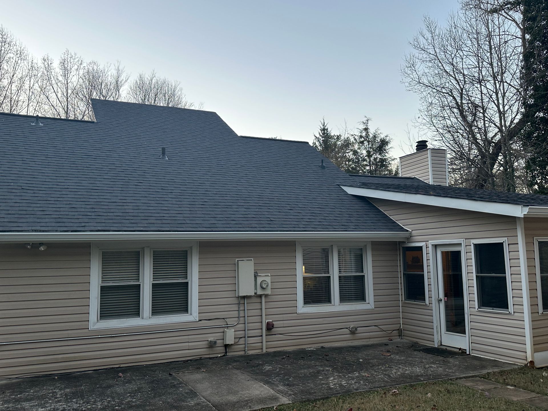A house with a slate roof and a lot of windows