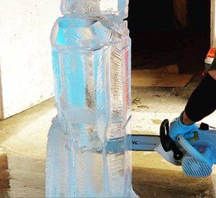 Chain saw carving the block of ice