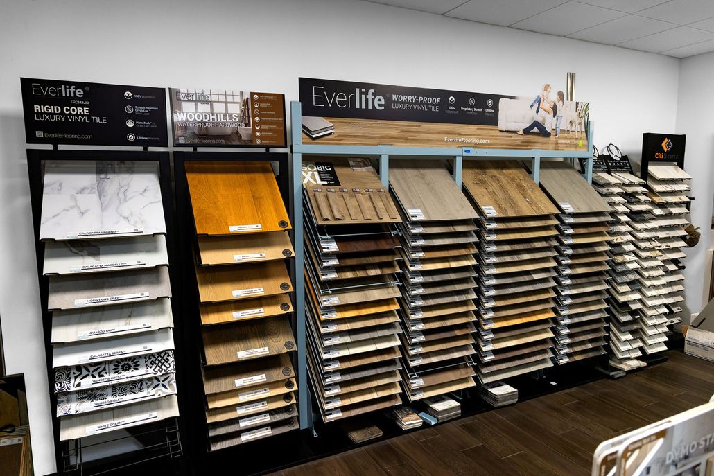 Display of shelves with assorted paper samples and cards in a store or showroom
